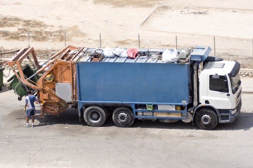 Workers handling segregated commercial waste containers safely